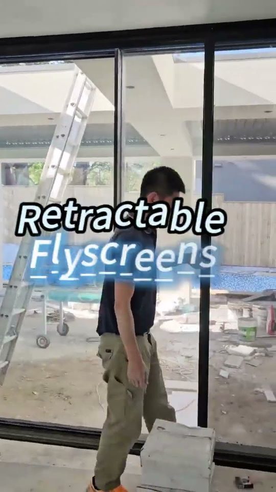 Retractable flyscreen fitted to a wide opening in a Sydney home, screen pulled across the doorway